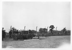 A photo taken in the 1860's using a Box Brownie Camera. The picture shows a group of firemen about to demonstrate the use of their large water pump.