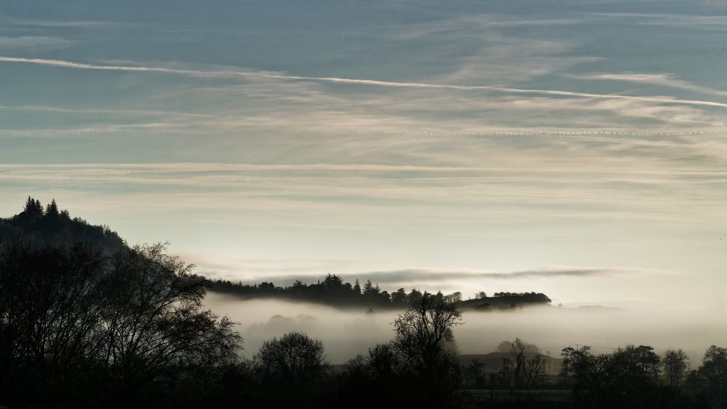 Image showing mist rising through the hills in early morning